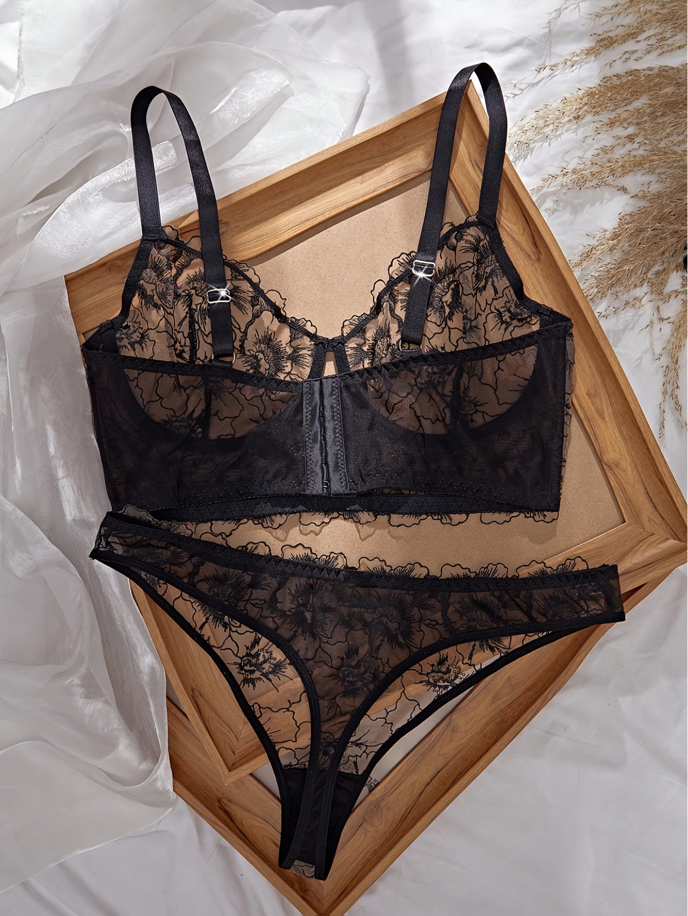 A Black Semi-Transparent Embroidered Plus-Size Bra And Panty Set, Designed for Curvy Women. This Exquisite Lingerie Set Features Delicate Embroidery, a Semi-Transparent Design, Floral Patterns, And a Lifting Effect