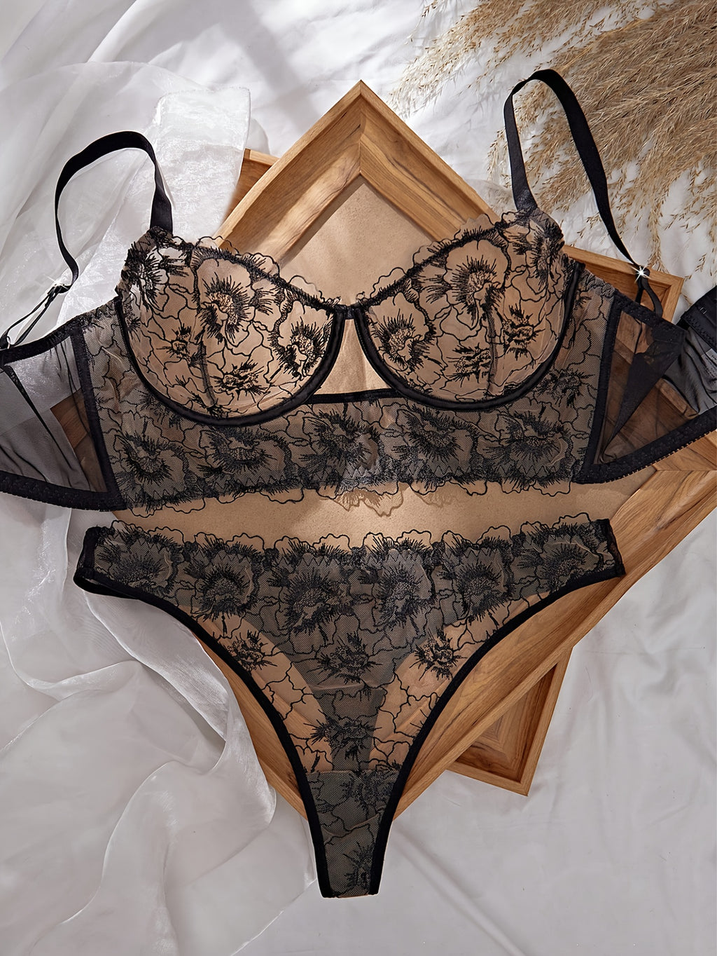 A Black Semi-Transparent Embroidered Plus-Size Bra And Panty Set, Designed for Curvy Women. This Exquisite Lingerie Set Features Delicate Embroidery, a Semi-Transparent Design, Floral Patterns, And a Lifting Effect