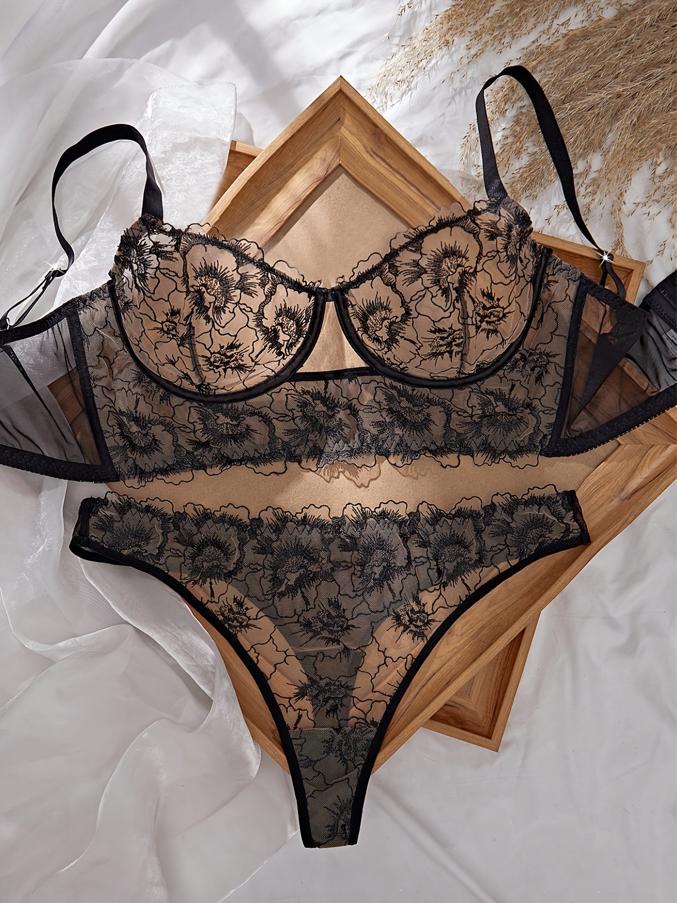 A Black Semi-Transparent Embroidered Plus-Size Bra And Panty Set, Designed for Curvy Women. This Exquisite Lingerie Set Features Delicate Embroidery, a Semi-Transparent Design, Floral Patterns, And a Lifting Effect