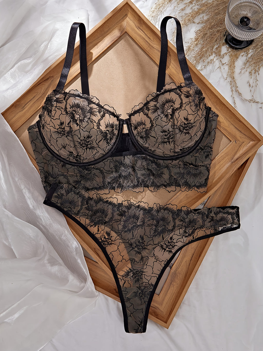 A Black Semi-Transparent Embroidered Plus-Size Bra And Panty Set, Designed for Curvy Women. This Exquisite Lingerie Set Features Delicate Embroidery, a Semi-Transparent Design, Floral Patterns, And a Lifting Effect