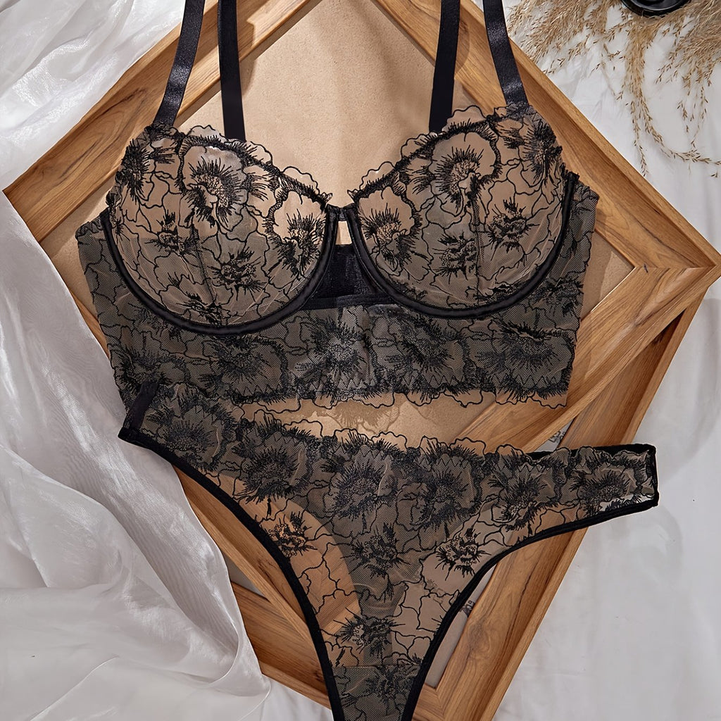 A Black Semi-Transparent Embroidered Plus-Size Bra And Panty Set, Designed for Curvy Women. This Exquisite Lingerie Set Features Delicate Embroidery, a Semi-Transparent Design, Floral Patterns, And a Lifting Effect