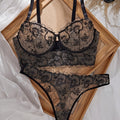 A Black Semi-Transparent Embroidered Plus-Size Bra And Panty Set, Designed for Curvy Women. This Exquisite Lingerie Set Features Delicate Embroidery, a Semi-Transparent Design, Floral Patterns, And a Lifting Effect